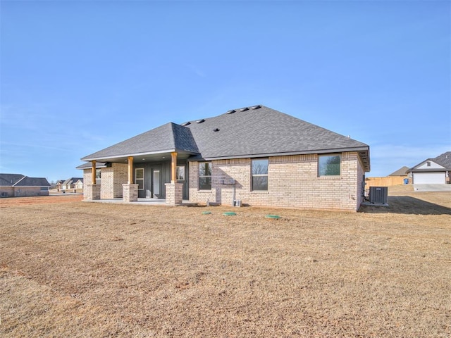 back of property featuring cooling unit, a yard, and a patio area