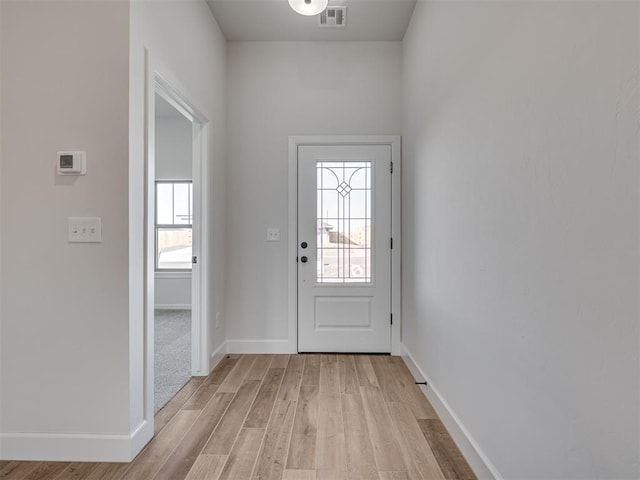 doorway with light wood-type flooring