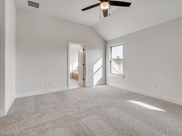 unfurnished room with ceiling fan, lofted ceiling, and light carpet