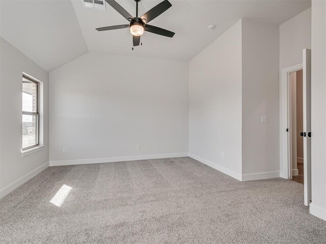 carpeted empty room with ceiling fan and lofted ceiling