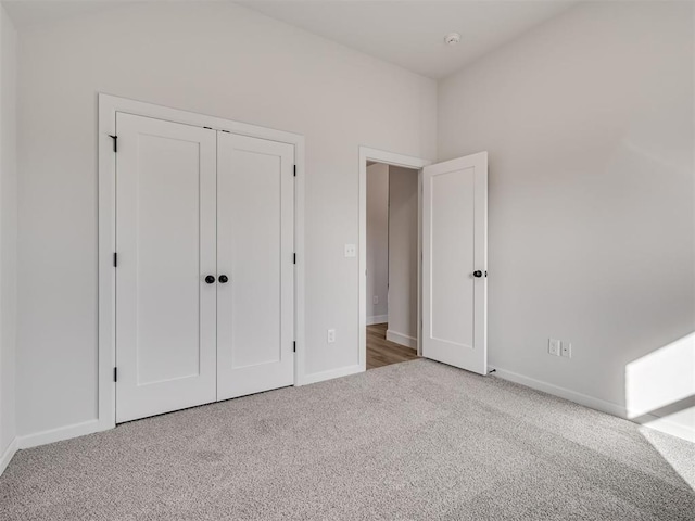 unfurnished bedroom with a closet and carpet