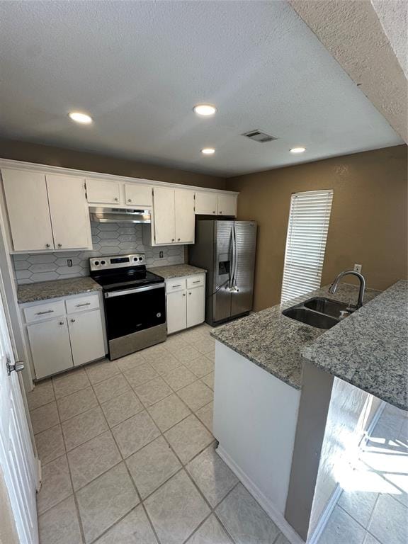 kitchen with sink, light stone countertops, tasteful backsplash, white cabinetry, and stainless steel appliances