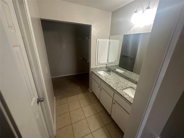 bathroom with tile patterned flooring and vanity