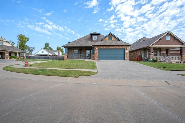 craftsman house with a garage and a front lawn