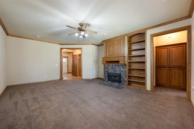 unfurnished living room with light carpet, ceiling fan, ornamental molding, and a tiled fireplace