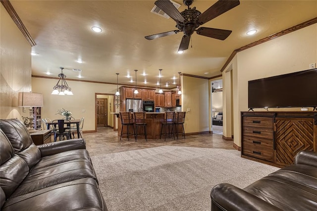 living room with crown molding, carpet floors, and ceiling fan with notable chandelier