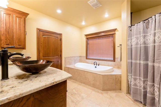 bathroom with vanity and independent shower and bath