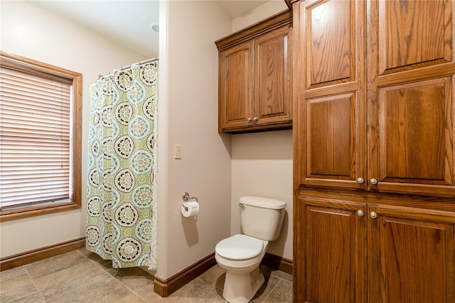 bathroom with tile patterned flooring and toilet