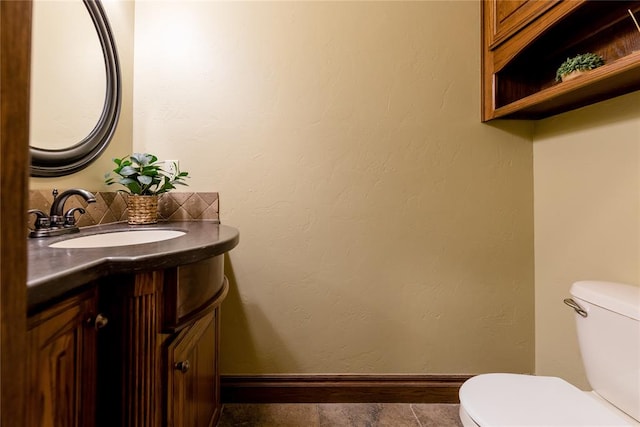 bathroom featuring tile patterned floors, vanity, and toilet