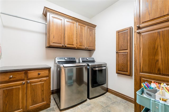 laundry room with washer and clothes dryer and cabinets