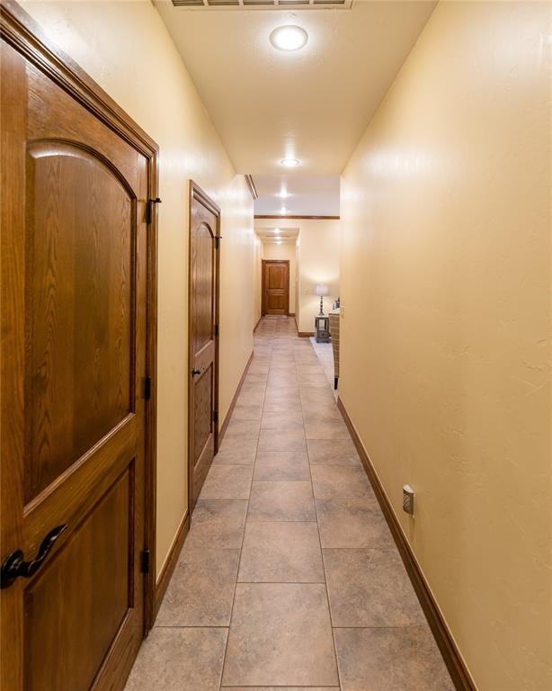 hallway featuring light tile patterned floors