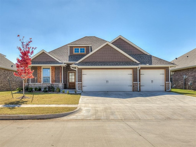 craftsman-style home featuring a garage and a front yard