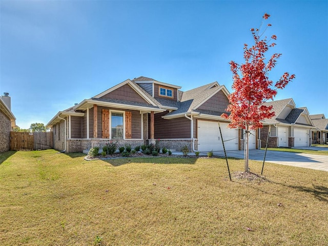 craftsman house featuring a front yard and a garage