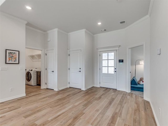 1718 Zayden Ln, Norman, OK 73072 - entrance foyer with independent washer and dryer, light wood-type flooring, and ornamental molding