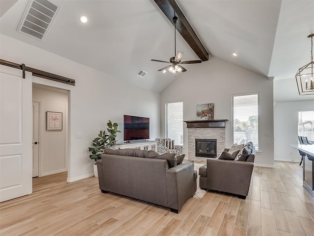 1718 Zayden Ln, Norman, OK 73072 - living room with beam ceiling, a barn door, high vaulted ceiling, and light wood-type flooring