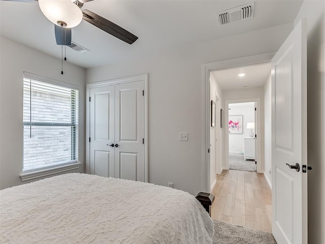 1718 Zayden Ln, Norman, OK 73072 - bedroom with ceiling fan, a closet, and light hardwood / wood-style floors