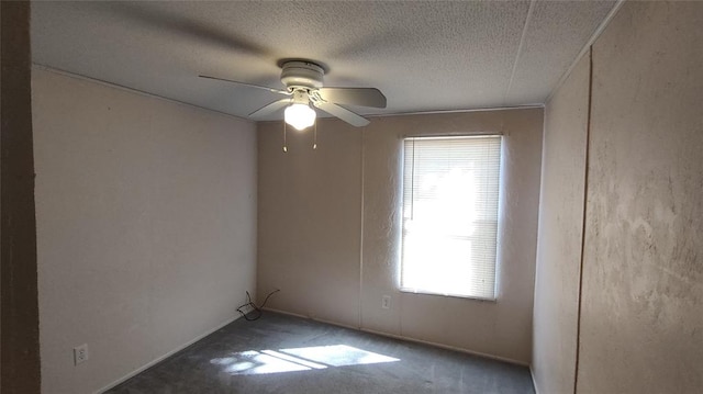 empty room with ceiling fan and a textured ceiling