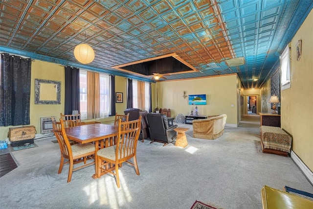 dining space with ornamental molding and heating unit