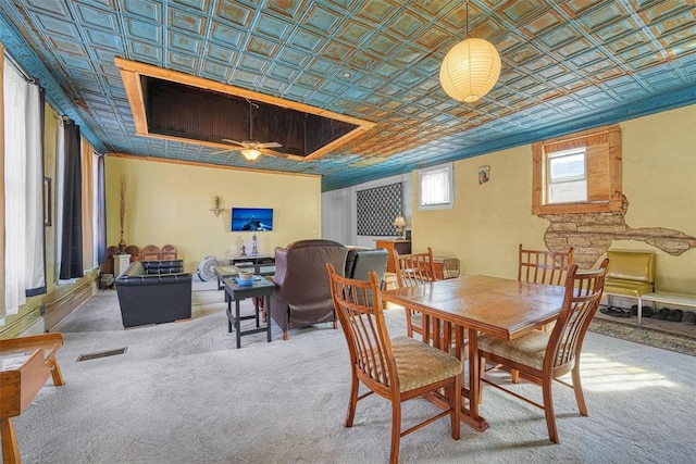 dining area featuring carpet flooring, ceiling fan, and crown molding