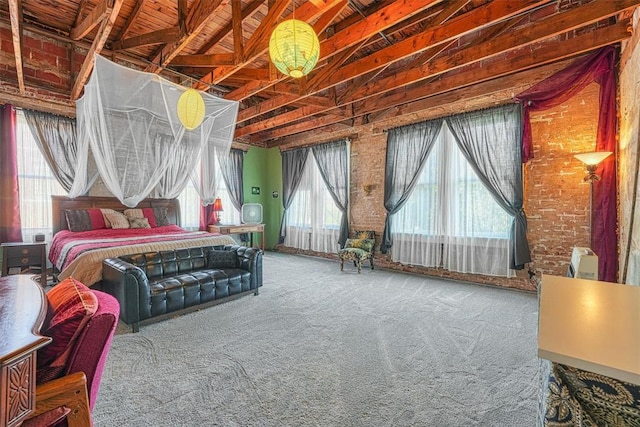 carpeted bedroom with beam ceiling, brick wall, and multiple windows