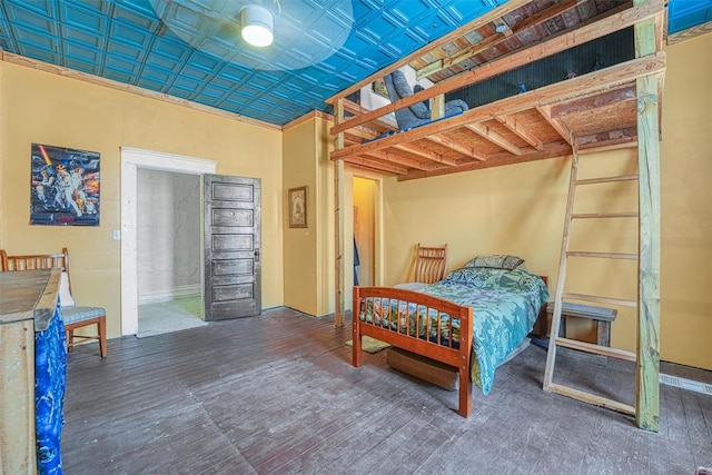 bedroom with dark wood-type flooring