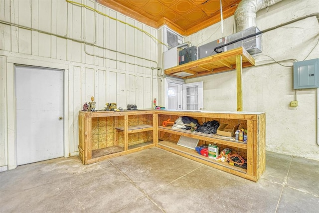 basement with a workshop area and electric panel