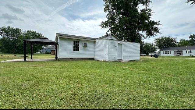 rear view of house with a gazebo and a yard