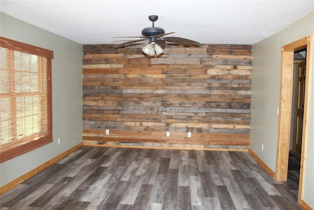 unfurnished dining area featuring ceiling fan, dark wood-type flooring, and a healthy amount of sunlight