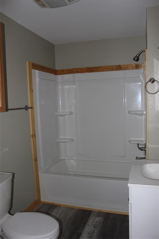 full bathroom with wood-type flooring, vanity, toilet, and shower / bathtub combination