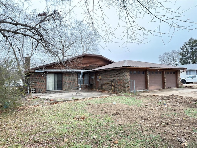 view of front facade featuring a garage and a patio