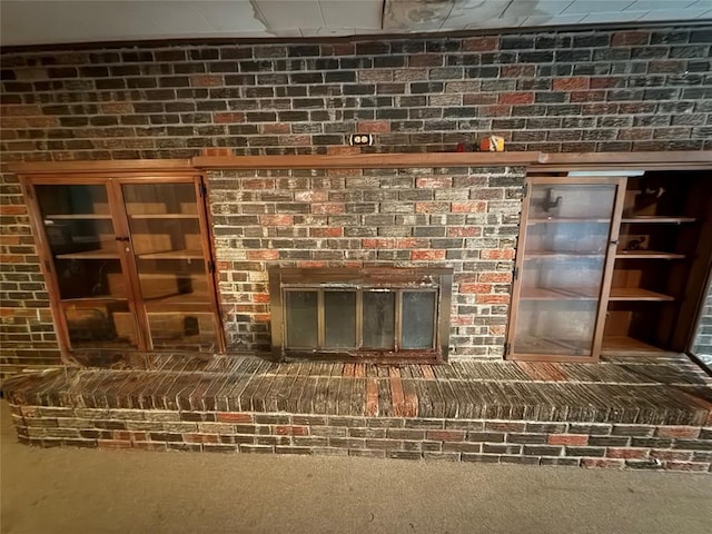 interior details featuring carpet floors and a fireplace