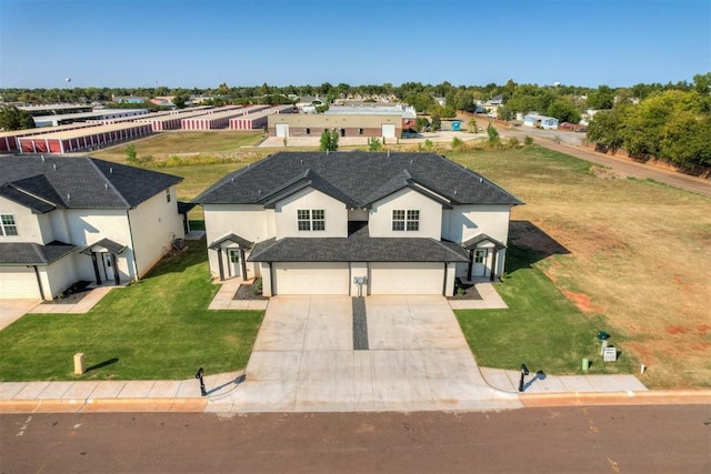 view of front of home with a garage and a front lawn