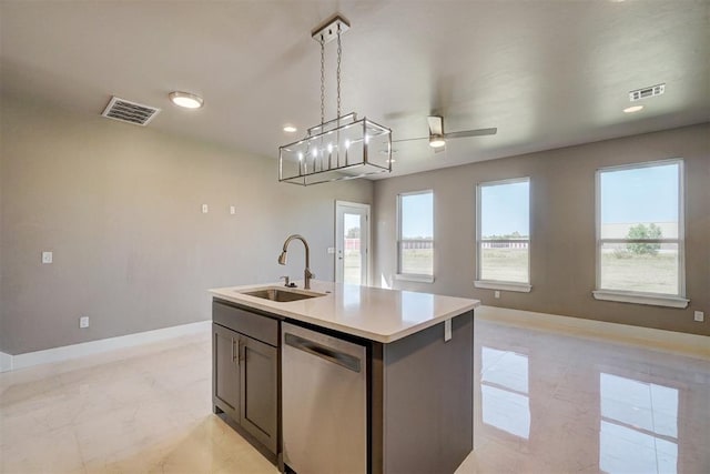 kitchen featuring dishwasher, a center island with sink, sink, ceiling fan, and decorative light fixtures