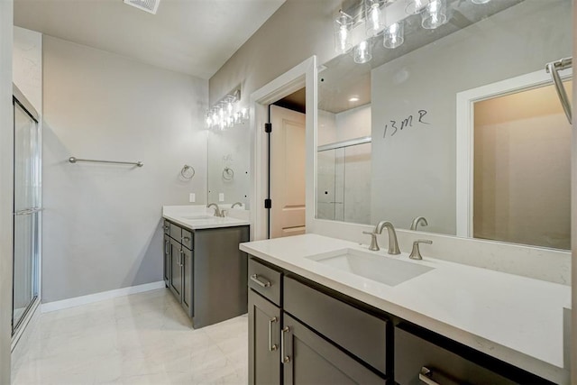 bathroom featuring a shower with door and vanity