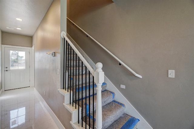 stairs featuring tile patterned floors