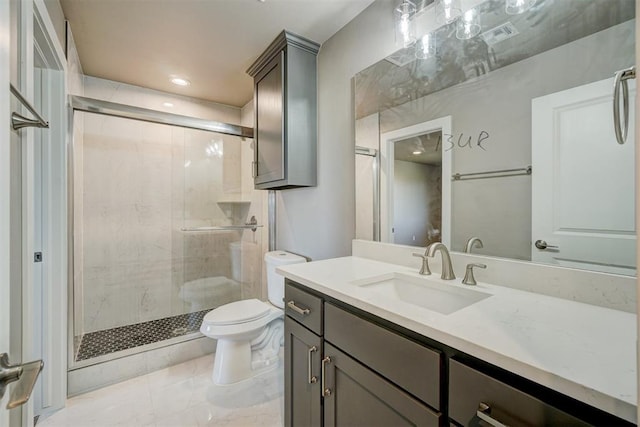 bathroom with vanity, toilet, and a shower with shower door