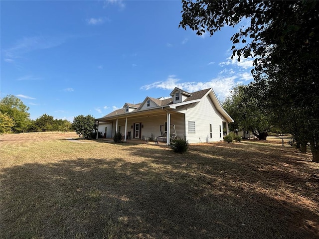 back of property featuring a lawn