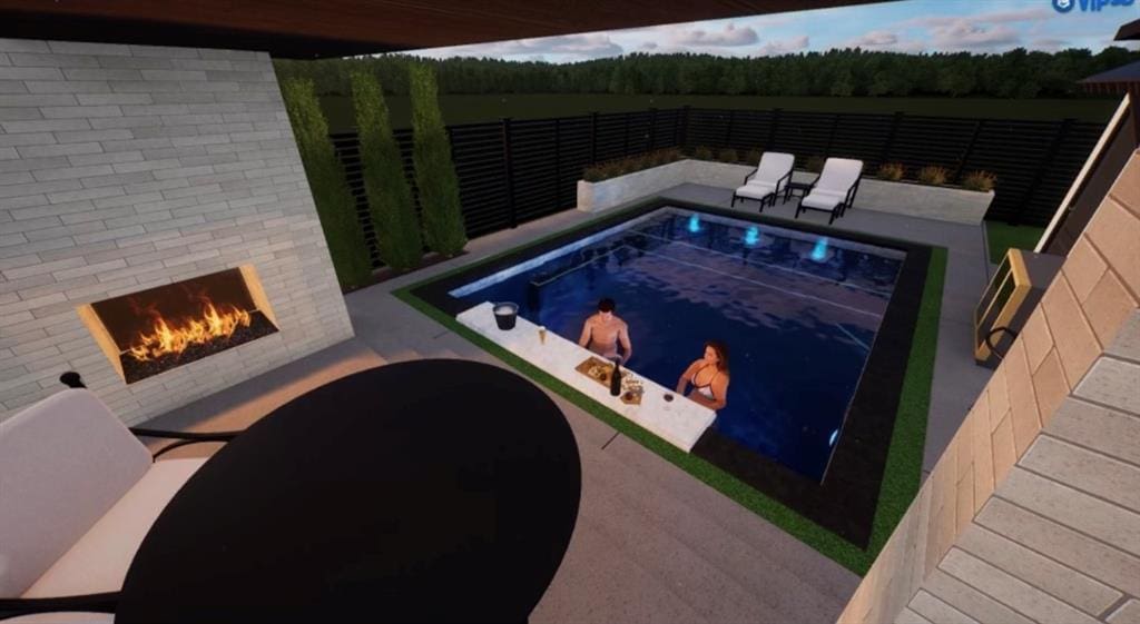 view of swimming pool featuring a patio and exterior fireplace