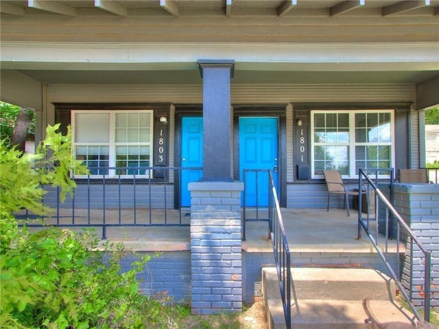 view of exterior entry with a porch