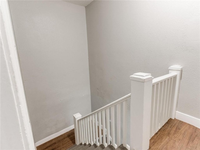 stairway with hardwood / wood-style floors