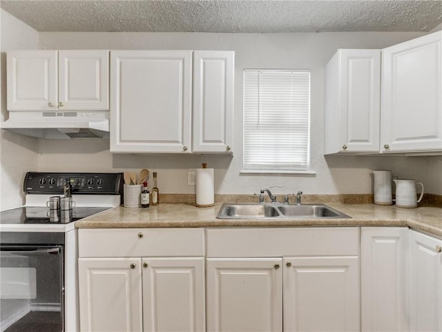 kitchen featuring white cabinets, white electric range oven, sink, and a textured ceiling