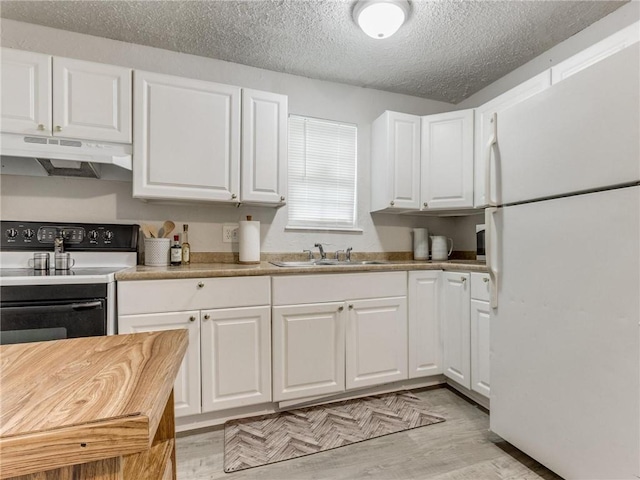 kitchen with white cabinets, white refrigerator, sink, electric range, and light wood-type flooring