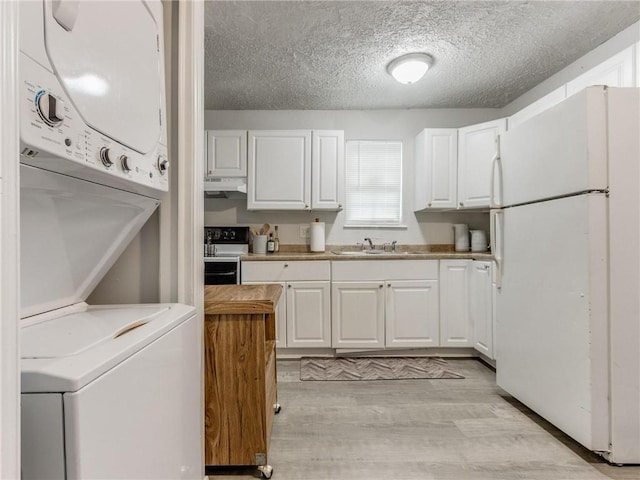 kitchen featuring white cabinets, white refrigerator, sink, light hardwood / wood-style flooring, and black range with electric cooktop