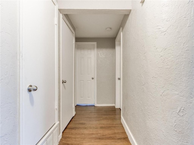 corridor featuring hardwood / wood-style floors