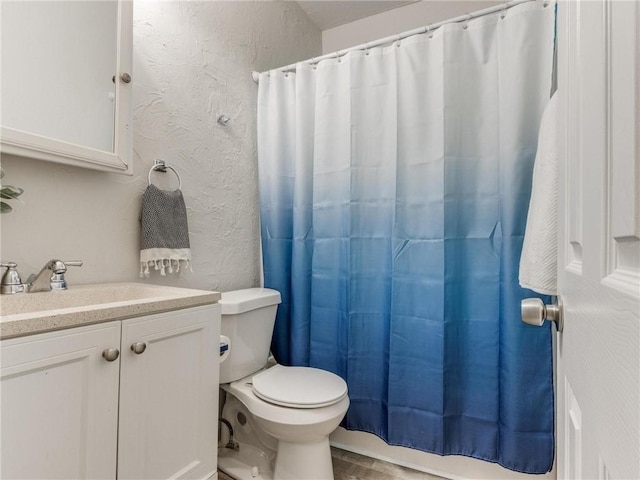 bathroom with hardwood / wood-style flooring, vanity, and toilet