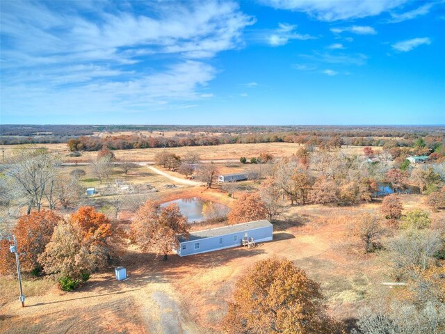 birds eye view of property with a rural view and a water view