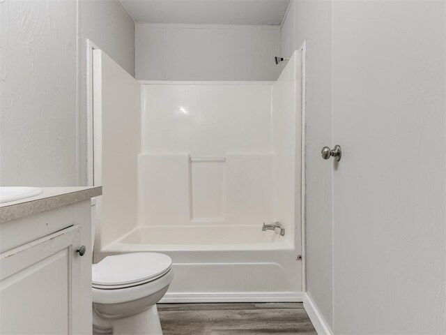 full bathroom featuring toilet, vanity, tub / shower combination, and hardwood / wood-style flooring