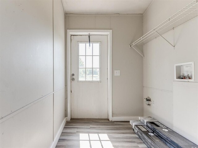 laundry room featuring hookup for a washing machine and light hardwood / wood-style flooring