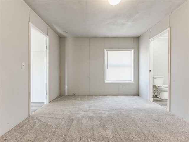 empty room featuring light colored carpet