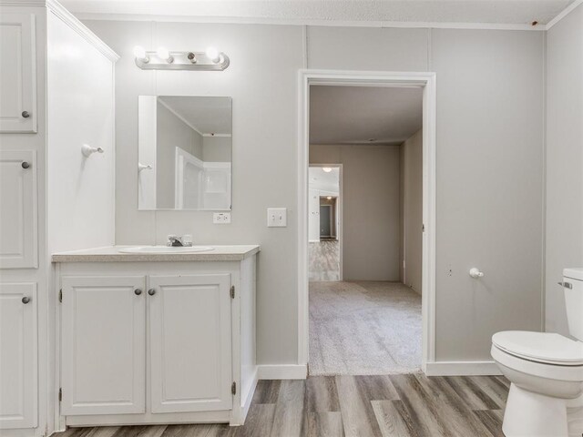 bathroom featuring hardwood / wood-style flooring, vanity, and toilet